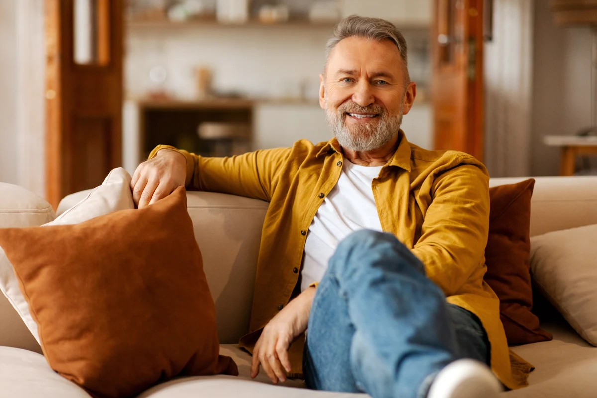 Smiling man relaxing on a sofa